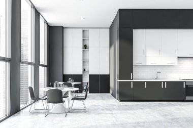 Tezgahı ve masası olan gri ve beyaz mutfak.