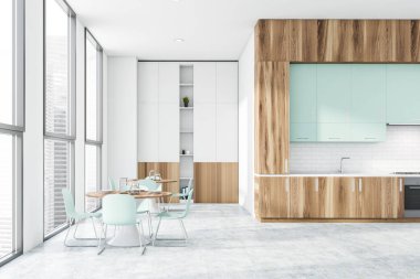 Tezgahı ve masası olan ahşap ve beyaz mutfak.