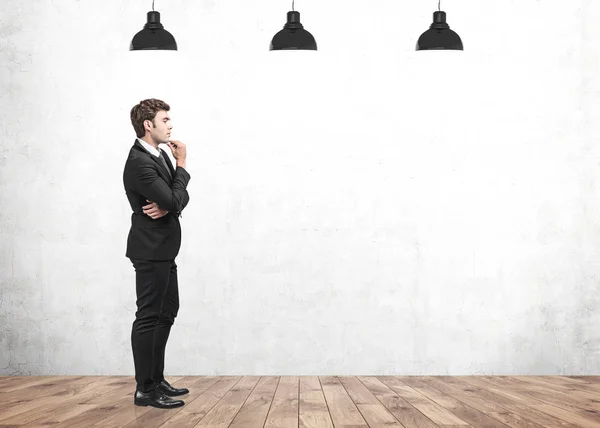 Side view of thoughtful young businessman in room — Stock Photo, Image