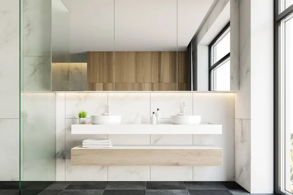 Double sink in white marble bathroom interior