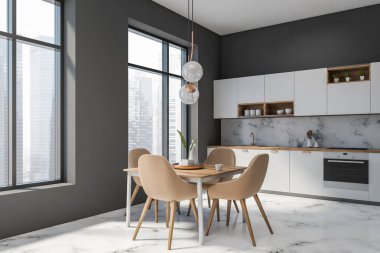 Gri ve mermer mutfak köşesinde masa var.