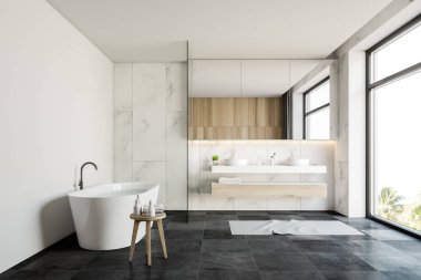 Beyaz mermer banyo içi lavabo ve küvetle dolu.