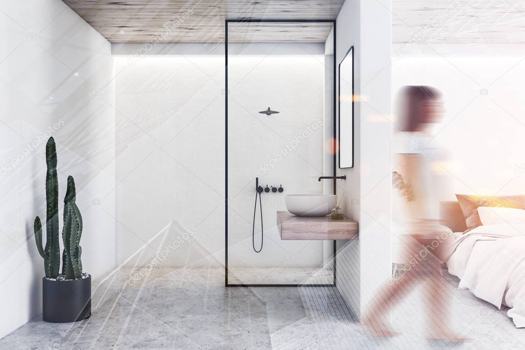 Girl walking in white bedroom with bathroom