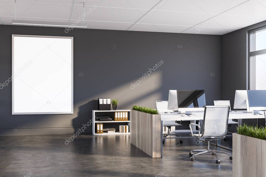 Gray office with dark wooden tables and poster