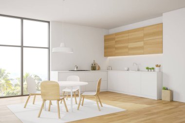 Beyaz ve ahşap mutfak köşesinde yemek masası var.