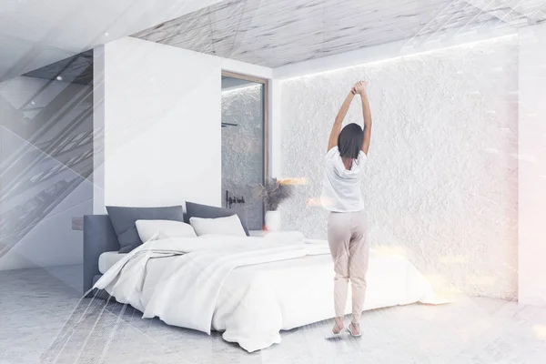 Woman in comfortable white bedroom with shower — Stockfoto