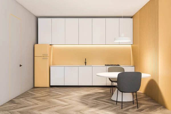 Yellow and white kitchen with fridge and table — Stock Photo, Image