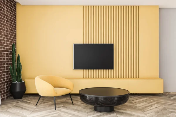 Sala de estar de ladrillo y amarillo con sillón y TV — Foto de Stock