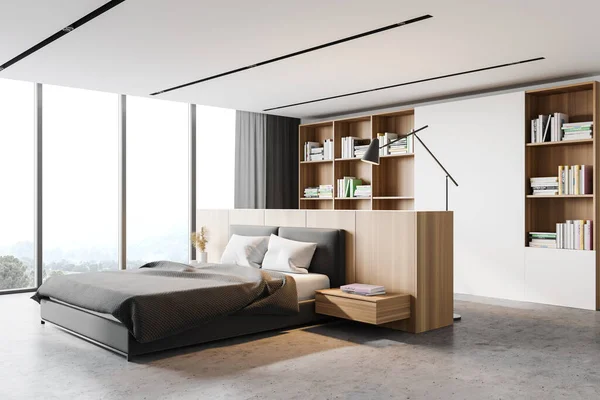 Corner of panoramic master bedroom with white walls, concrete floor, comfortable king size bed, bookcase and window with blurry mountain view. 3d rendering