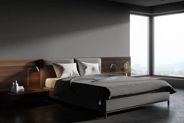 Corner of Scandinavian style bedroom with gray and wooden walls, concrete floor, grey king size bed and window with blurry mountain scenery. 3d rendering