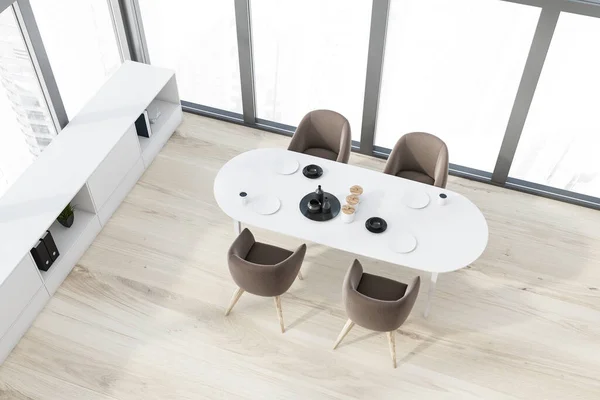 Top view of stylish panoramic dining room with wooden floor, long oval white table with brown armchairs and white bookshelf. Blurry cityscape. 3d rendering