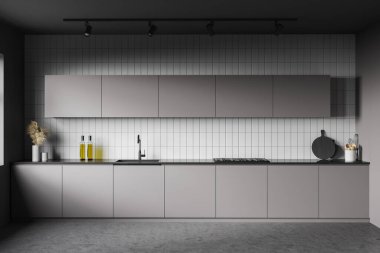 Gri ve beyaz fayanslı duvarları, beton zemini, gri dolapları ve mutfak tezgahları olan şık bir mutfak. 3d oluşturma