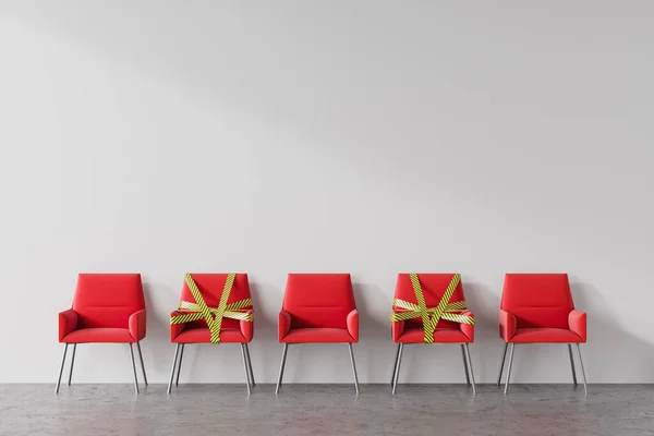 Row of red chairs standing in public place with white walls. Some of them are covered with barrier tape. Concept of social distancing and covid 19 lockdown easing. 3d rendering