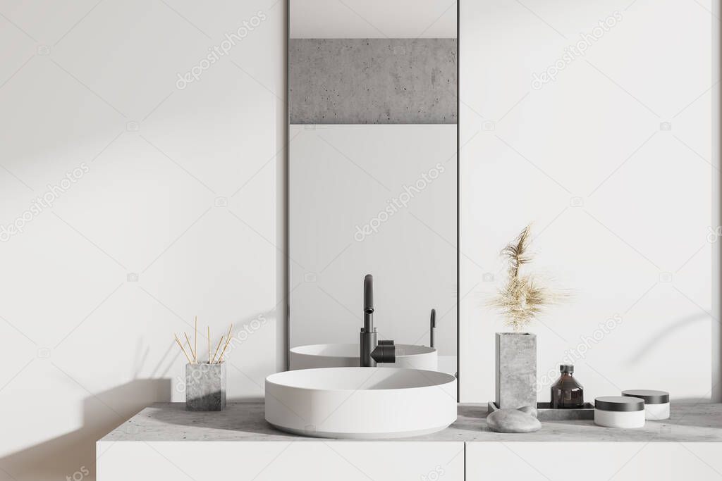 Close up of round sink with vertical mirror standing in on white shelf in modern bathroom with white and stone walls. 3d rendering