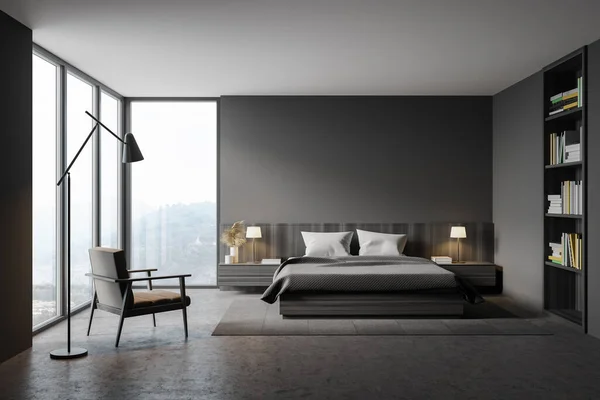 Interior of stylish master bedroom with gray walls, concrete floor, comfortable king size bed, armchair and window with blurry mountain view. Built in bookcase. 3d rendering