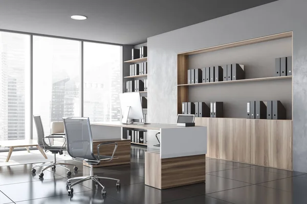 Corner of modern CEO office with grey walls, tiled floor, wooden computer table with chairs for visitors and bookcases with folders. Window with blurry cityscape. 3d rendering