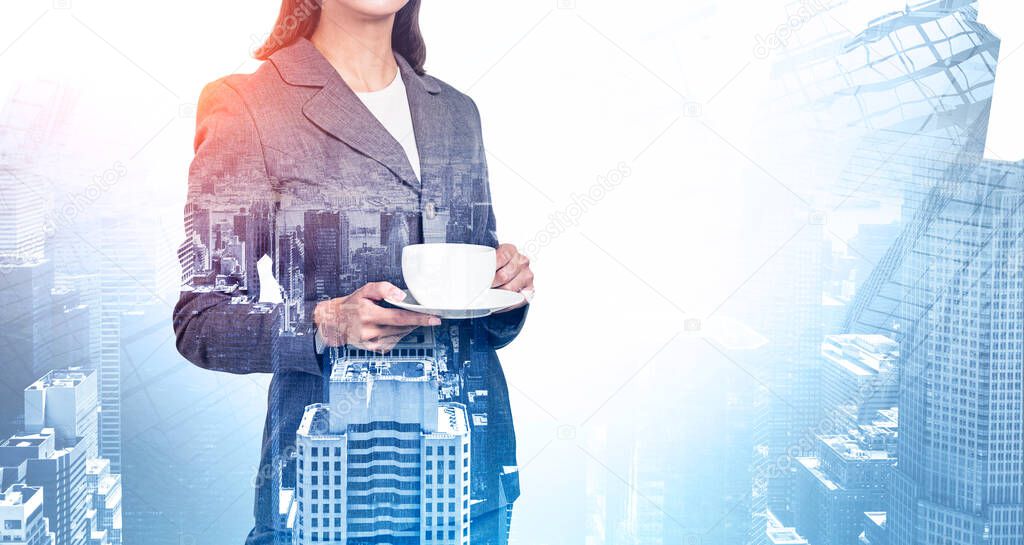 Unrecognizable young businesswoman holding cup and saucer in blurry abstract city. Concept of leadership and coffee break. Toned image double exposure