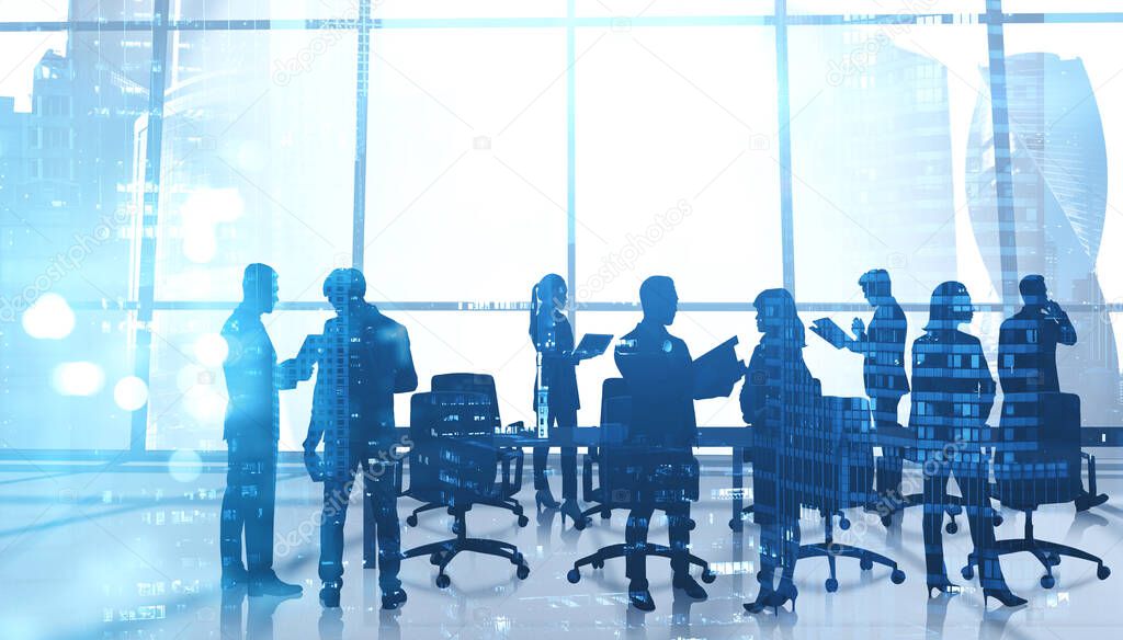 Silhouettes of business people working together in modern office with double exposure of blurry Moscow city panorama. Concept of teamwork and corporate lifestyle. Toned image