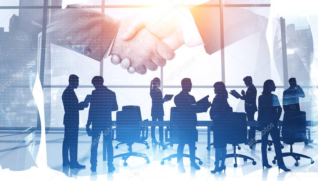 Two businessmen shaking hands in blurry abstract city office with their colleagues in foreground. Concept of partnership and sealing a deal. Toned image double exposure