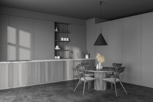 グレーの壁 コンクリートの床 暗い木製のカウンターと食器棚とグレーの椅子とラウンドダイニングテーブルとスタイリッシュなキッチンのコーナー 3Dレンダリング — ストック写真
