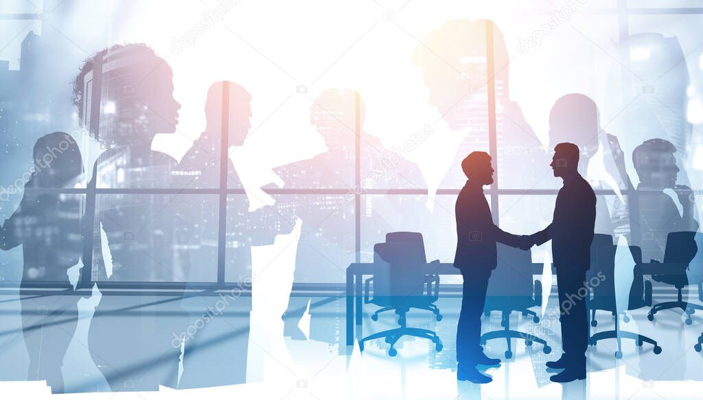 Silhouettes of two businessmen shaking hands in panoramic meeting room with double exposure of blurry abstract cityscape and diverse business people. Concept of partnership. Toned image