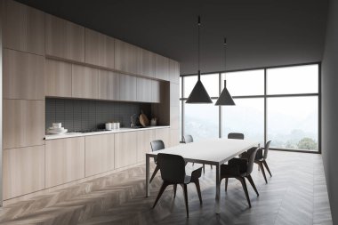 Gri duvarlı şık bir mutfak, ahşap zemin, ahşap tezgah ve dolaplar, sandalyeli yemek masası ve bulanık dağ manzaralı panoramik pencere. 3d oluşturma