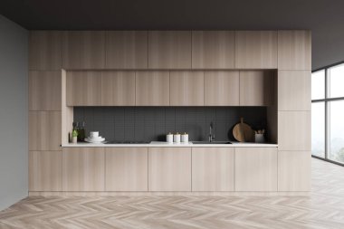 Gri duvarları, ahşap zemini, ahşap dolapları ve teçhizatlı tezgahları olan şık minimalist mutfağın içi. Bulanık dağ manzaralı bir pencere. 3d oluşturma