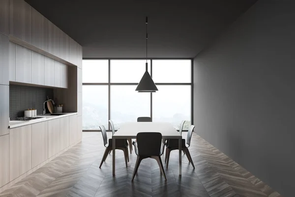 有灰色墙壁 木制地板 木制台面和橱柜的时尚厨房侧视图 有椅子的餐桌和有模糊山景的全景窗 3D渲染 — 图库照片