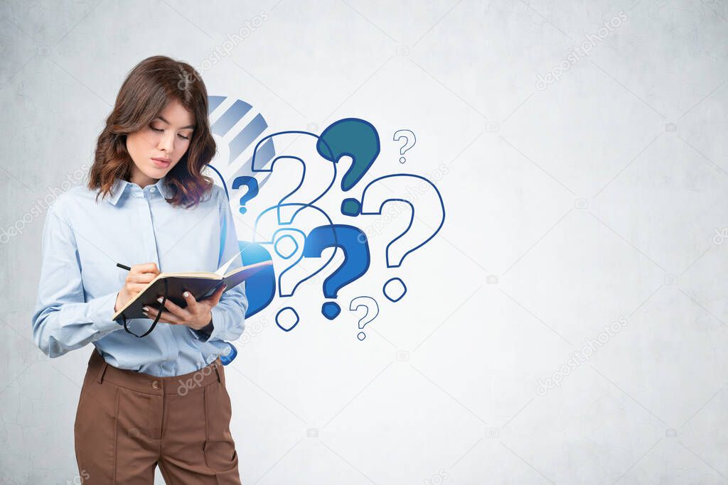 Serious beautiful young businesswoman or student writing in notebook near concrete wall with colorful question marks drawn on it. Concept of choice and education. Mock up