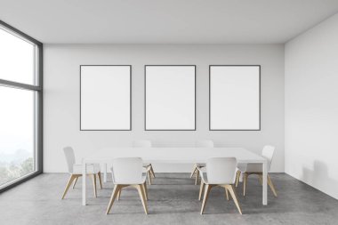 Minimalist yemek odasının içinde beyaz duvarlar, beton zemin, sandalyeli beyaz masa ve poster galerisi. Bulanık dağ manzaralı bir pencere. 3d oluşturma