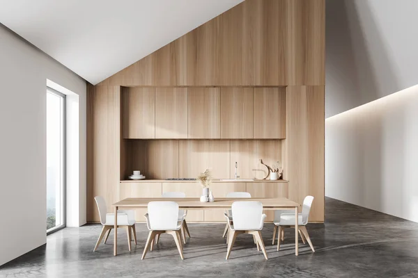 现代阁楼厨房的正面景观 有白色和木制墙壁 混凝土地面 木制台面和有白色椅子的餐桌 山景朦胧的窗户 3D渲染 — 图库照片