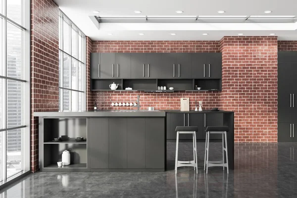 Interior of stylish kitchen with brick walls, concrete floor, gray cupboards and countertops, bar with stools and window with blurry cityscape. 3d rendering