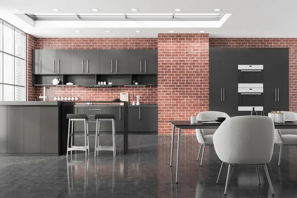 Interior of stylish kitchen with brick walls, comfortable dining table with gray armchairs and bar with stools and countertops standing near window with blurry cityscape. 3d rendering