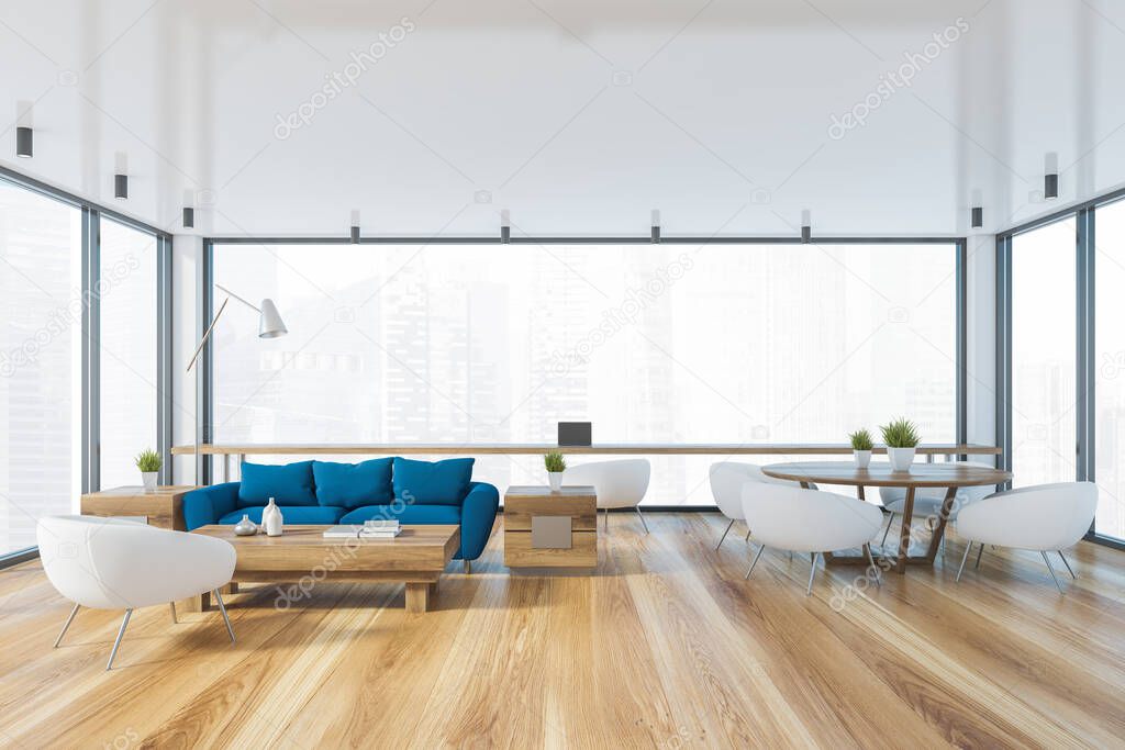 Interior of panoramic living room with blue sofa, coffee table, round dining table with white armchairs and home office area near window with blurry cityscape. 3d rendering