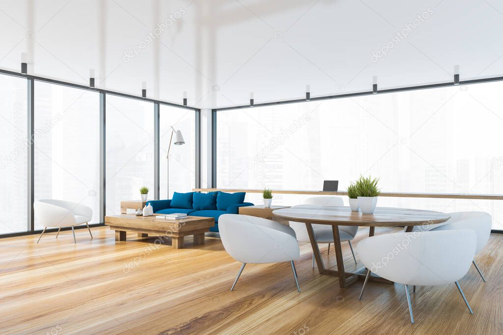 Corner of spacious living room with blue sofa, coffee table, round dining table with white armchairs and home office area near window with blurry cityscape. 3d rendering