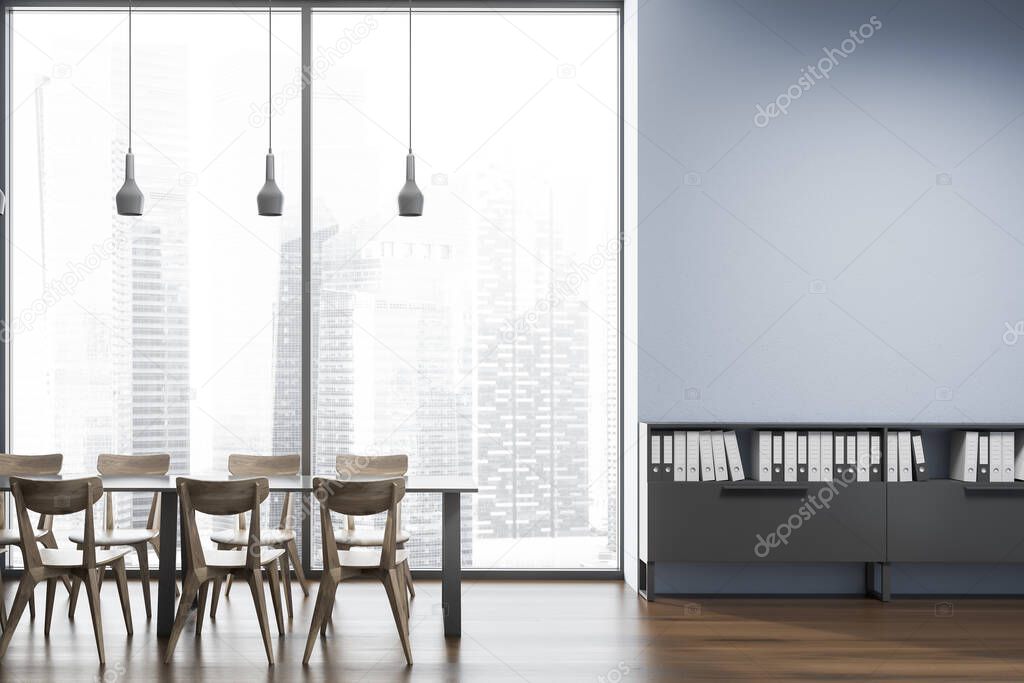 Interior of stylish office cafe with blue walls, wooden floor, gray dining table with wooden chairs and shelves with folders. Blurry cityscape. 3d rendering