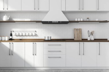 Beyaz tuğlalı duvarları, beton zemini, beyaz ve ahşap dolapları ve lavabo ve ocakta yapılmış tezgahları olan modern mutfağın içi. 3d oluşturma