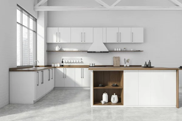 Interior of modern kitchen with white brick walls, concrete floor, white and wooden cupboards, island and countertops with built in sink and cooker. Window with blurry cityscape. 3d rendering