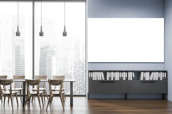 Interior of stylish office cafe with blue walls, wooden floor, gray dining table with wooden chairs and horizontal mock up poster hanging above shelves with folders. Blurry cityscape. 3d rendering
