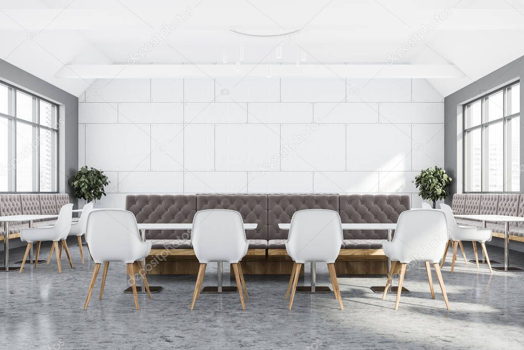 Interior of stylish restaurant with white and gray walls, concrete floor, long white tables with chairs and comfortable brown sofas. Window with blurry cityscape. 3d rendering