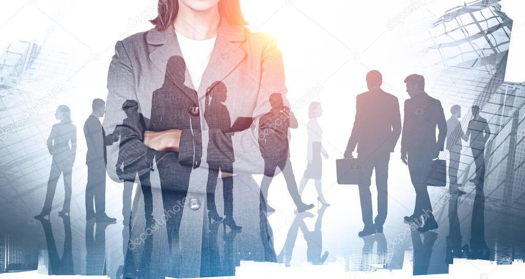 Unrecognizable confident businesswoman standing with crossed arms in blurry abstract city with double exposure of her team. Concept of leadership. Toned image