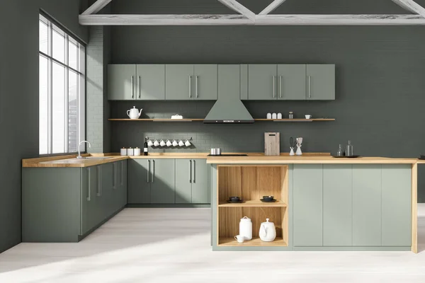 Interior of stylish kitchen with gray brick walls, wooden floor, gray and wooden cupboards, island and countertops with built in sink and cooker. Window with blurry cityscape. 3d rendering