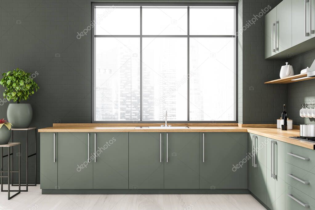 Interior of stylish kitchen with gray brick walls, wooden floor, gray and wooden cupboards and countertops with built in sink and cooker. Window with blurry cityscape. 3d rendering