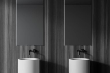Yuvarlak çift lavabo, iki dikey ayna ve koyu ahşap duvarlı şık bir banyoda duruyor. 3d oluşturma