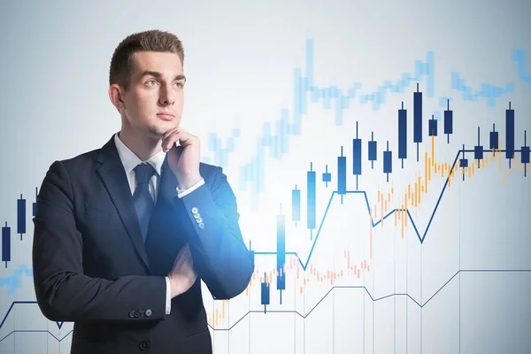 Pensive Young Businessman Blurry Blue Background Financial Graphs Stock Market — Stock Photo, Image