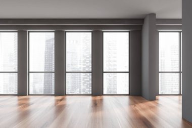 Gri duvarları, ahşap zemini ve panoramik penceresi olan boş bir ofis. Bulanık şehir manzarası. 3d oluşturma