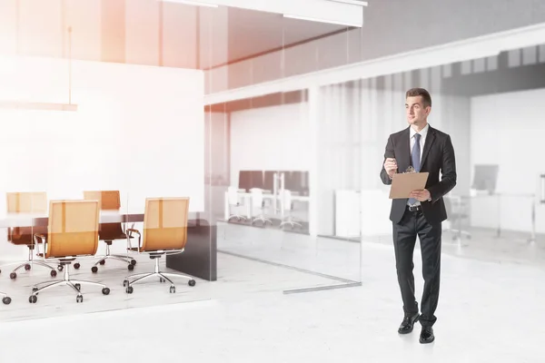 Confident Young Businessman Clipboard Walking Modern Office Concept Management Toned — Stock Photo, Image