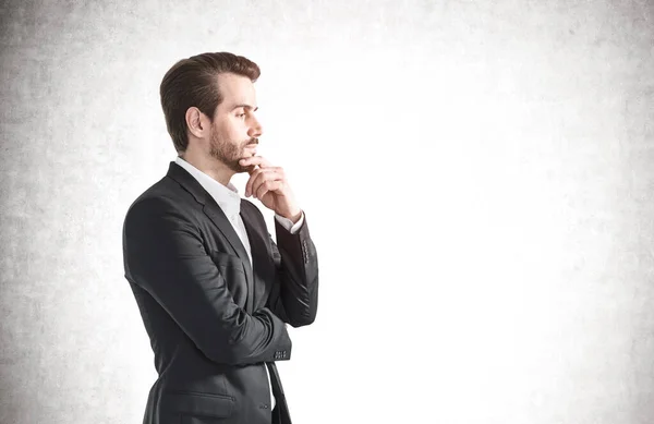 Side Portrait Thoughtful Young Businessman Beard Wearing Elegant Suit Concrete — Stock Photo, Image