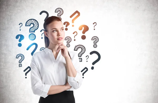 Portrait Pensive Young Businesswoman Standing Concrete Wall Question Marks Written — Stock Photo, Image