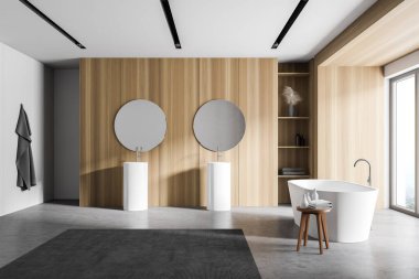 Modern banyo, beyaz ve ahşap duvarlar, beton zemin, rahat küvet ve yuvarlak aynalı çift lavabo. 3d oluşturma